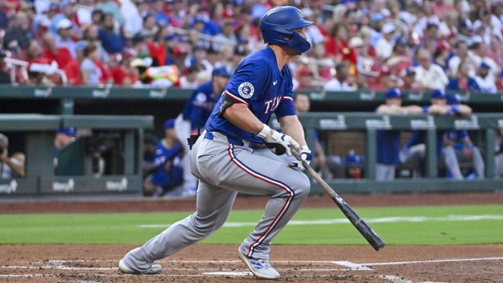 Jul 29, 2024; St. Louis, Missouri, USA; Texas Rangers shortstop Corey Seager (5) hits a one run double against the St. Louis Cardinals during the third inning at Busch Stadium.