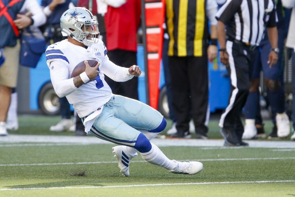 Sep 27, 2020; Seattle, Washington, USA; Dallas Cowboys quarterback Dak Prescott (4) scrambles against the Seattle Seahawks during the fourth quarter at CenturyLink Field.