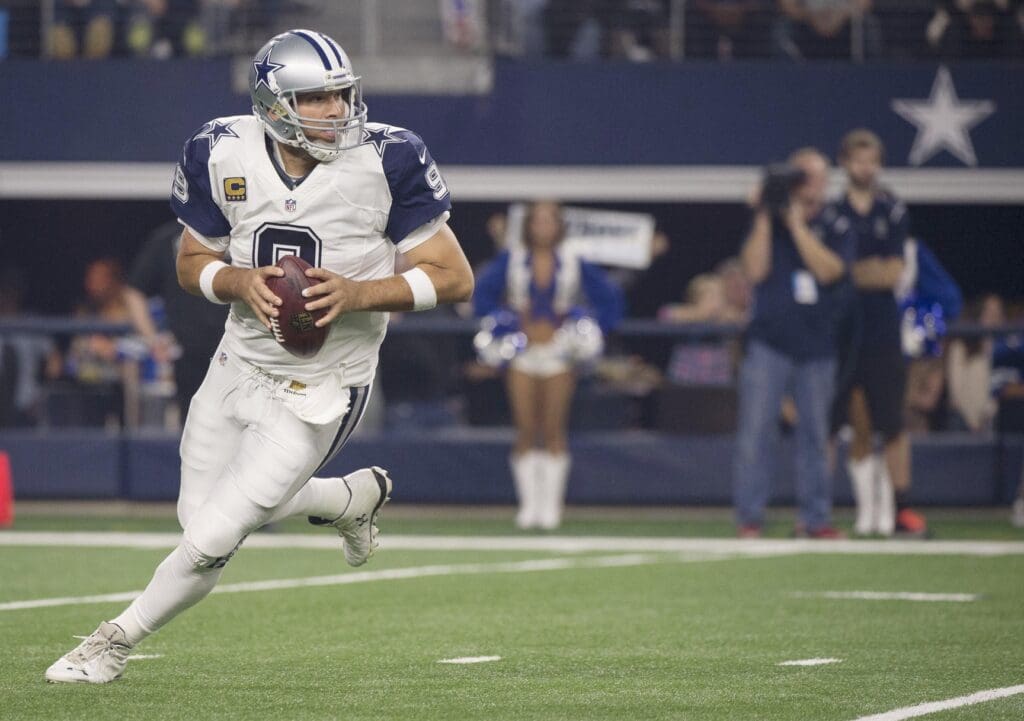 Nov 26, 2015; Arlington, TX, USA; Dallas Cowboys quarterback Tony Romo (9) rolls out to pass against the Carolina Panthers during the first quarter of an NFL game on Thanksgiving at AT&T Stadium.