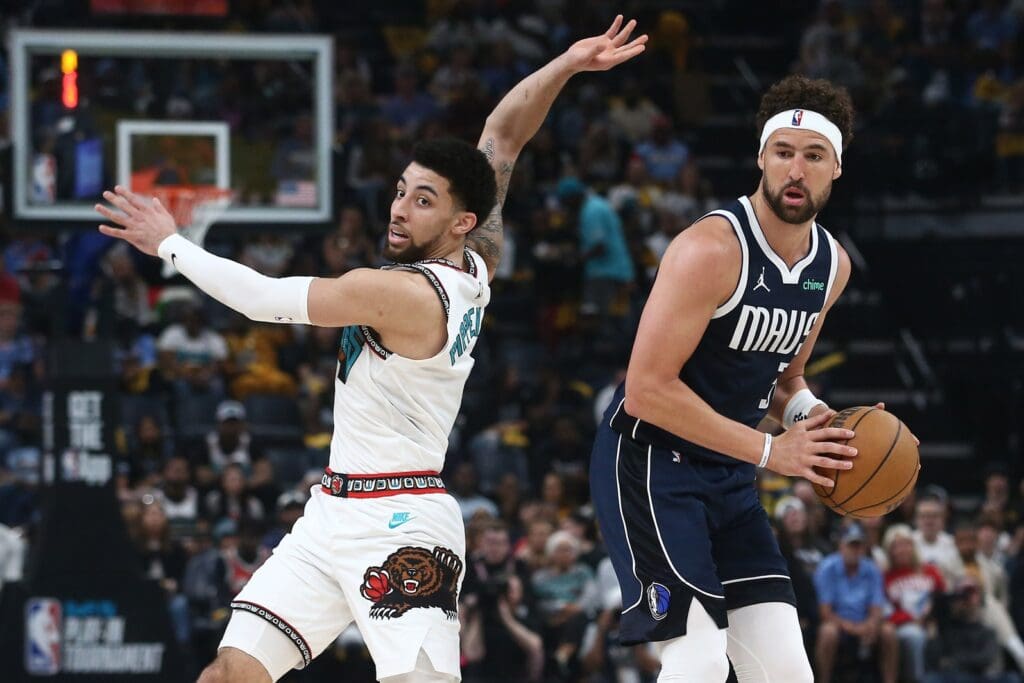 Apr 18, 2025; Memphis, Tennessee, USA; Dallas Mavericks guard Klay Thompson (31) pump fakes Memphis Grizzlies guard Scotty Pippen Jr. (1) during the second quarter at FedExForum.