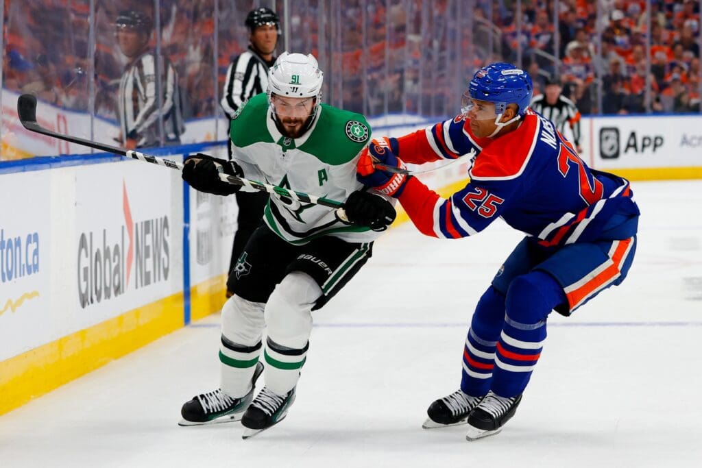 May 25, 2025; Edmonton, Alberta, CAN; Dallas Stars center Tyler Seguin (91) and Edmonton Oilers defenseman Darnell Nurse (25) chase the puck during the second period in game three of the Western Conference Final of the 2025 Stanley Cup Playoffs at Rogers Place.