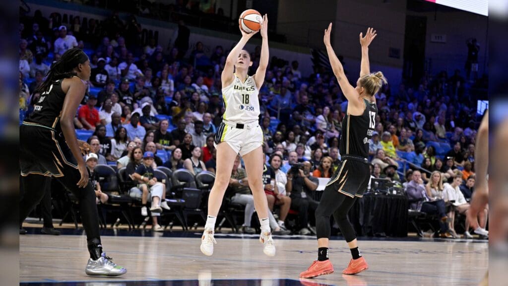Jul 28, 2025; Arlington, Texas, USA; Dallas Wings center Luisa Geiselsoder (18) makes a jump shot over New York Liberty forward Leonie Fiebich (13) during the first half at College Park Center