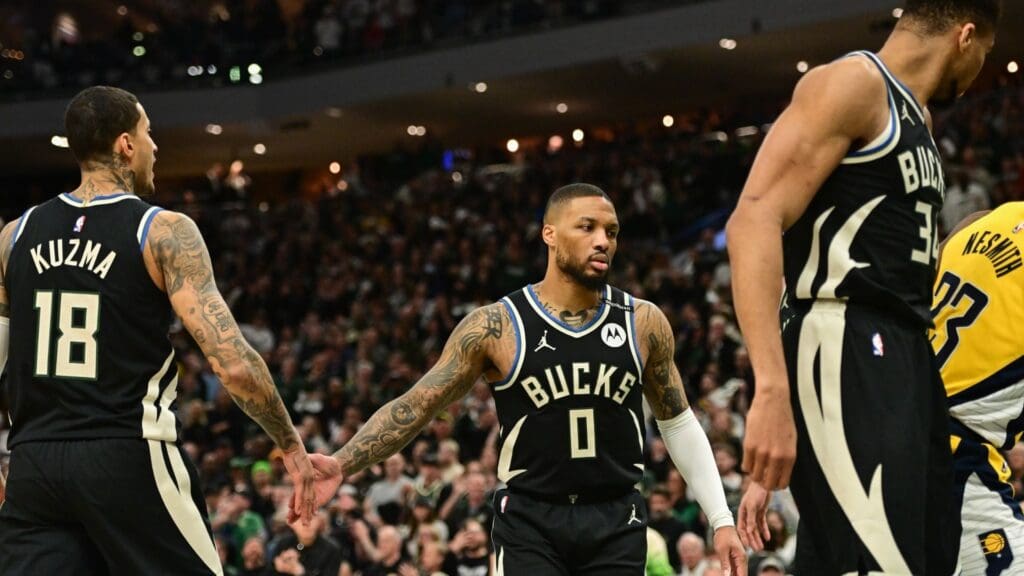 Apr 27, 2025; Milwaukee, Wisconsin, USA; Milwaukee Bucks guard Damian Lillard (0) reacts with forward Kyle Kuzma (18) in the first quarter against the Indiana Pacers during game four of first round for the 2024 NBA Playoffs at Fiserv Forum. Lillard left the game early in the in the first quarter with an injury.