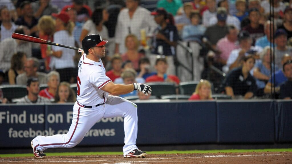 August 12, 2011; Atlanta, GA, USA; Atlanta Braves second baseman Dan Uggla (26) hits his second homerun against the Chicago Cubs during the fifth inning at Turner Field.