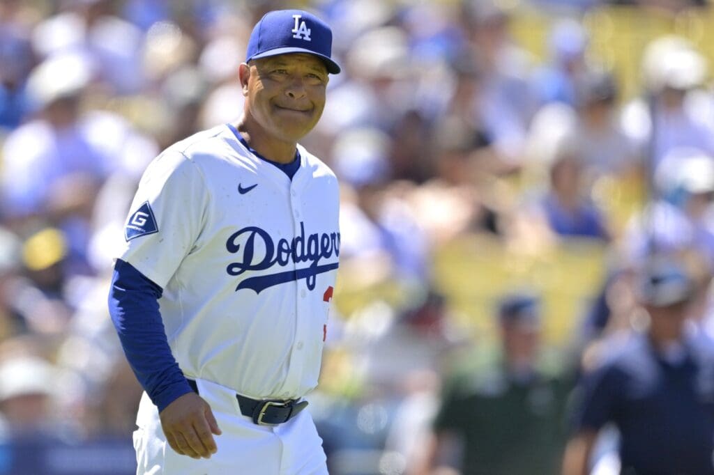 Jul 6, 2025; Los Angeles, California, USA; Los Angeles Dodgers manager Dave Roberts (30) walks to the mound for a pitching change in the eighth inning against the Houston Astros at Dodger Stadium.