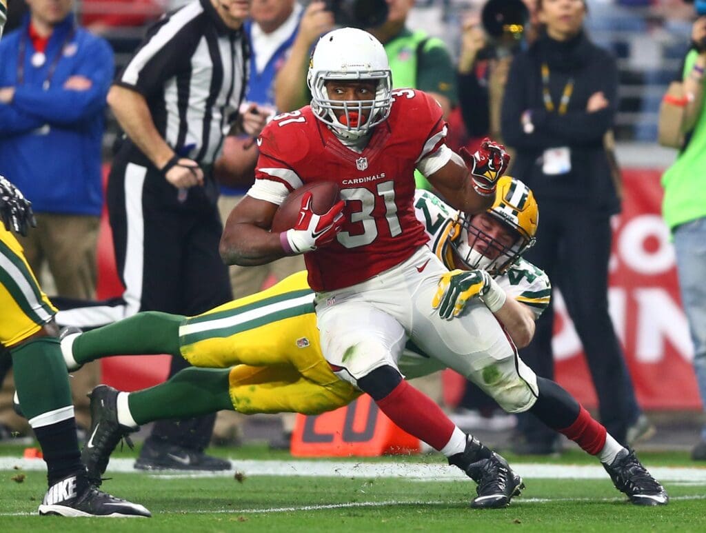 Dec 27, 2015; Glendale, AZ, USA; Arizona Cardinals running back David Johnson (31) is tackled by diving Green Bay Packers linebacker Jake Ryan (47) in the first half at University of Phoenix Stadium. The Cardinals defeated the Packers 38-8