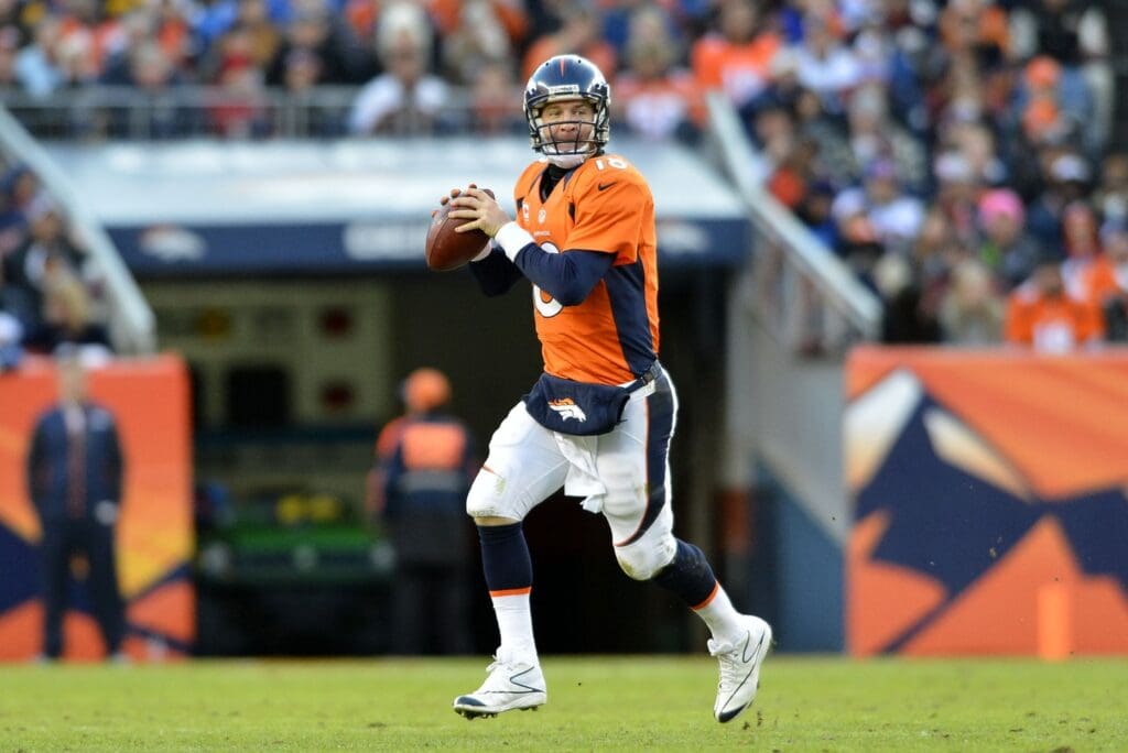 Dec 23 2012; Denver, CO, USA; Denver Broncos quarterback Peyton Manning (18) scrambles in the fourth quarter against the Cleveland Browns at Sports Authority Field. The Broncos defeated the Browns 34-12.