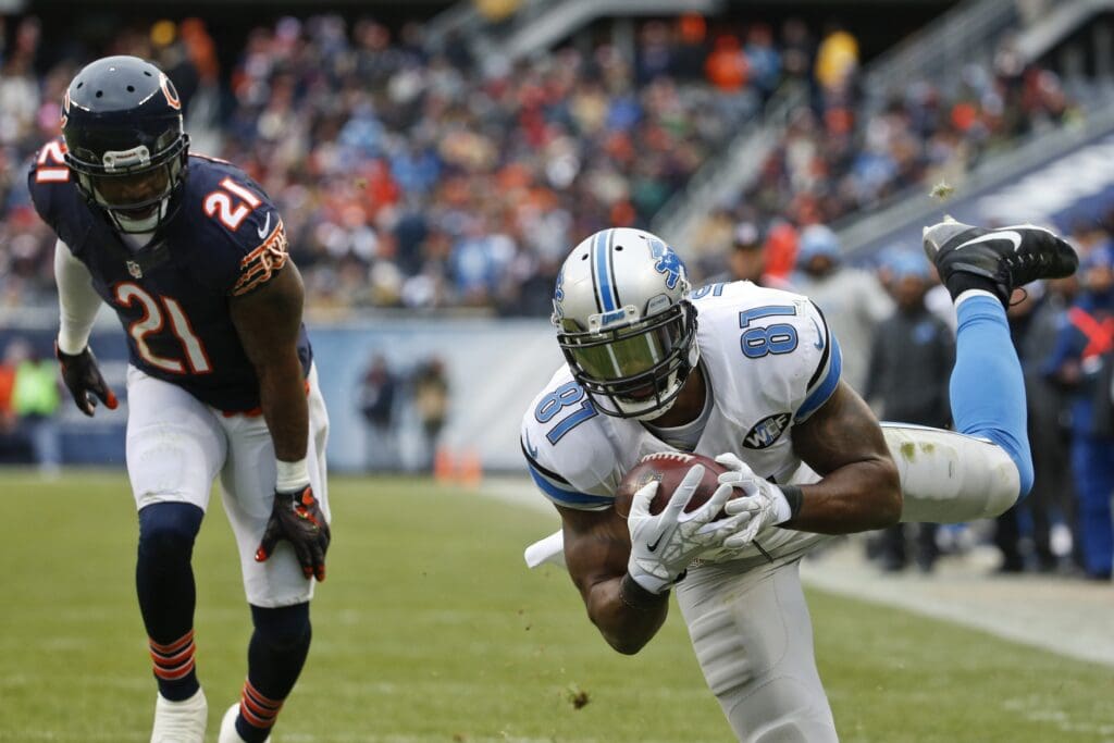 Jan 3, 2016; Chicago, IL, USA; Detroit Lions wide receiver Calvin Johnson (81) catches a touchdown pass against Chicago Bears strong safety Ryan Mundy (21) during the second half at Soldier Field. The Lions won 24-20.