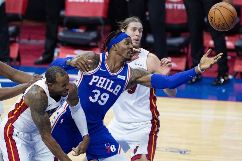 Jan 12, 2021; Philadelphia, Pennsylvania, USA; Philadelphia 76ers center Dwight Howard (39) reaches for a loose ball past Miami Heat forward Andre Iguodala (28) during the third quarter at Wells Fargo Center.