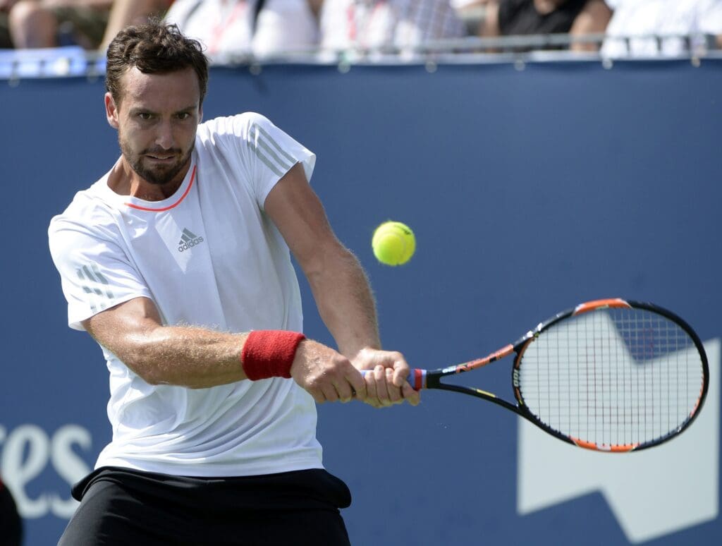 Aug 13, 2015; Montreal, Quebec, Canada; Ernests Gulbis of Latvia hits the ball against Donald Young of the United States (not pictured) during the Rogers Cup tennis tournament at Uniprix Stadium. 