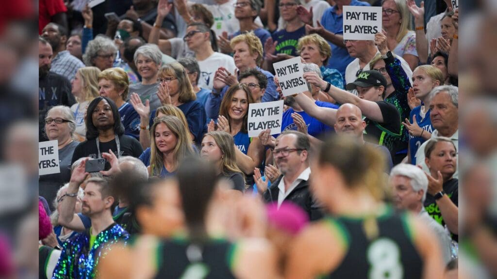 Jul 30, 2025; Minneapolis, Minnesota, USA; Fans hold up signs to Pay the Players before the game between the Minnesota Lynx and New York Liberty at Target Center