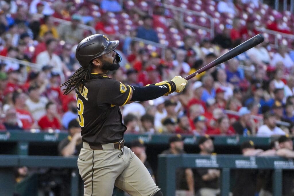 Jul 24, 2025; St. Louis, Missouri, USA; San Diego Padres right fielder Fernando Tatis Jr. (23) hits a solo home run against the St. Louis Cardinals during the third inning at Busch Stadium. Mandatory Credit: