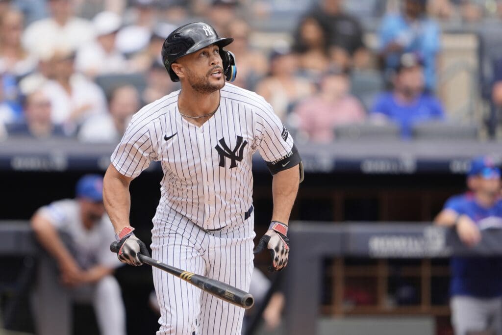 Jul 13, 2025; Bronx, New York, USA; New York Yankees designated hitter Giancarlo Stanton (27) watches his home run against the Chicago Cubs during the second inning at Yankee Stadium. 