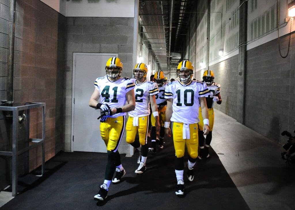 Jan. 10, 2010; Glendale, AZ, USA; Green Bay Packers linebacker Spencer Havner (41), quarterback Aaron Rodgers (12) and quarterback Matt Flynn (10) lead the team out to the field prior to the game against the Arizona Cardinals in the 2010 NFC wild card playoff game at University of Phoenix Stadium. Arizona defeated Green Bay 51-45 in overtime.