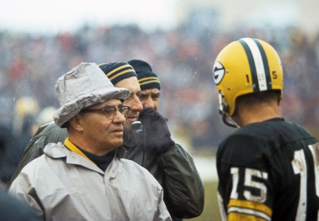 Jan 2, 1966; Cleveland, OH, USA; FILE PHOTO; Green Bay Packers head coach Vince Lombardi talks to quarterback Bart Starr (15) against the Cleveland Browns during the 1965 NFL Championship game at Cleveland Stadium.