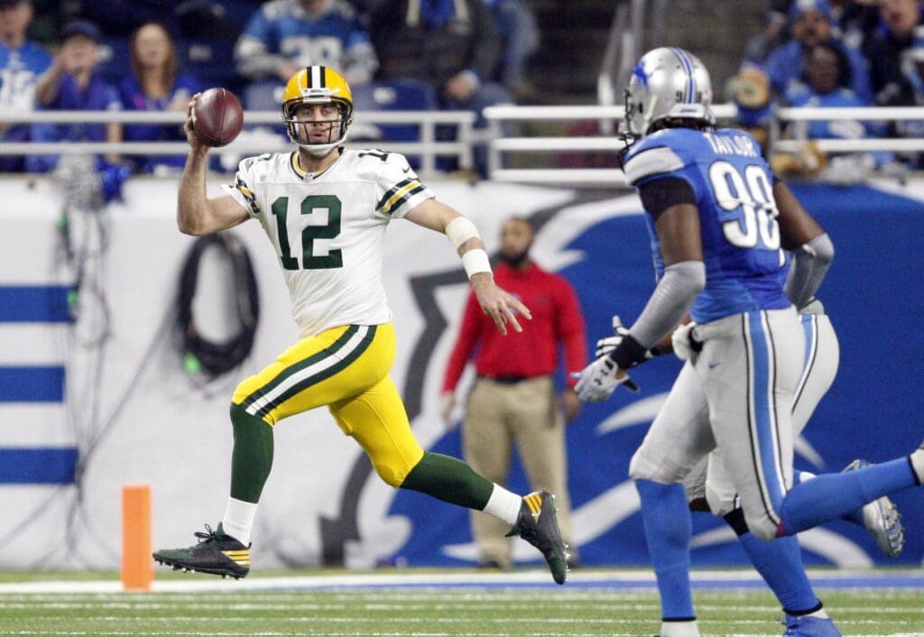 Jan 1, 2017; Detroit, MI, USA; Green Bay Packers quarterback Aaron Rodgers (12) gets chased by Detroit Lions defensive end Devin Taylor (98) during the second quarter at Ford Field. Packers won 31-24.