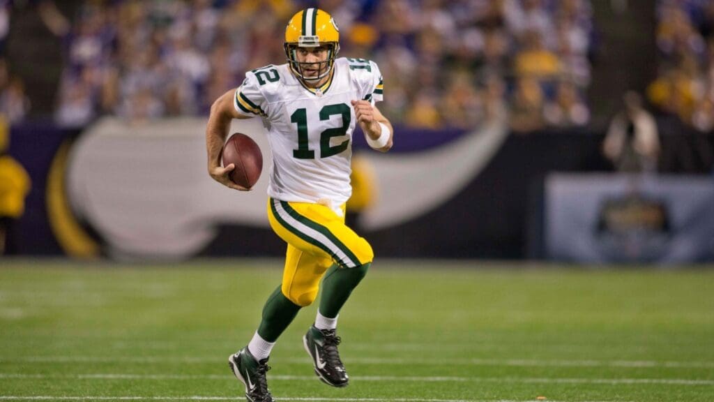 Oct 27, 2013; Minneapolis, MN, USA; Green Bay Packers quarterback Aaron Rodgers (12) rushes against the Minnesota Vikings in the third quarter at Mall of America Field at H.H.H. Metrodome. The Packers win 44-31. 