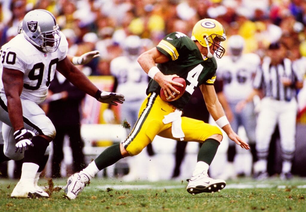 Sep 12, 1999; Green Bay, WI, USA; FILE PHOTO; Green Bay Packers quarterback Brett Favre (4) in action against Oakland Raiders defensive tackle Grady Jackson (90) at Lambeau Field.