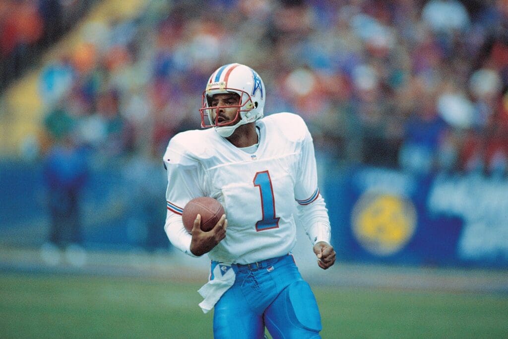 Sep 1986; Unknown location, USA; FILE PHOTO; Houston Oilers quarterback Warren Moon (1) scrambles with the ball.