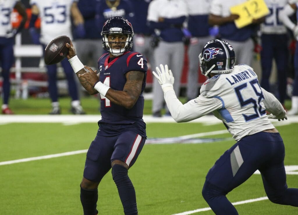 Jan 3, 2021; Houston, Texas, USA; Houston Texans quarterback Deshaun Watson (4) attempts a pass as Tennessee Titans outside linebacker Harold Landry (58) defends during the fourth quarter at NRG Stadium.