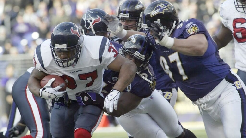 Houston Texans running back Domanick Davis (37) is tackled by Baltimore Ravens defenders Bart Scott (57) and Kelly Gregg (97) during 1st half action of the Texans matchup with the Ravens at M & T Bank Stadium
