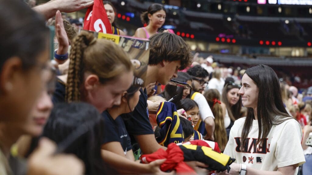 Jul 27, 2025; Chicago, Illinois, USA; Indiana Fever guard Caitlin Clark (22) signs autographs before a WNBA game against the Chicago Sky at United Center