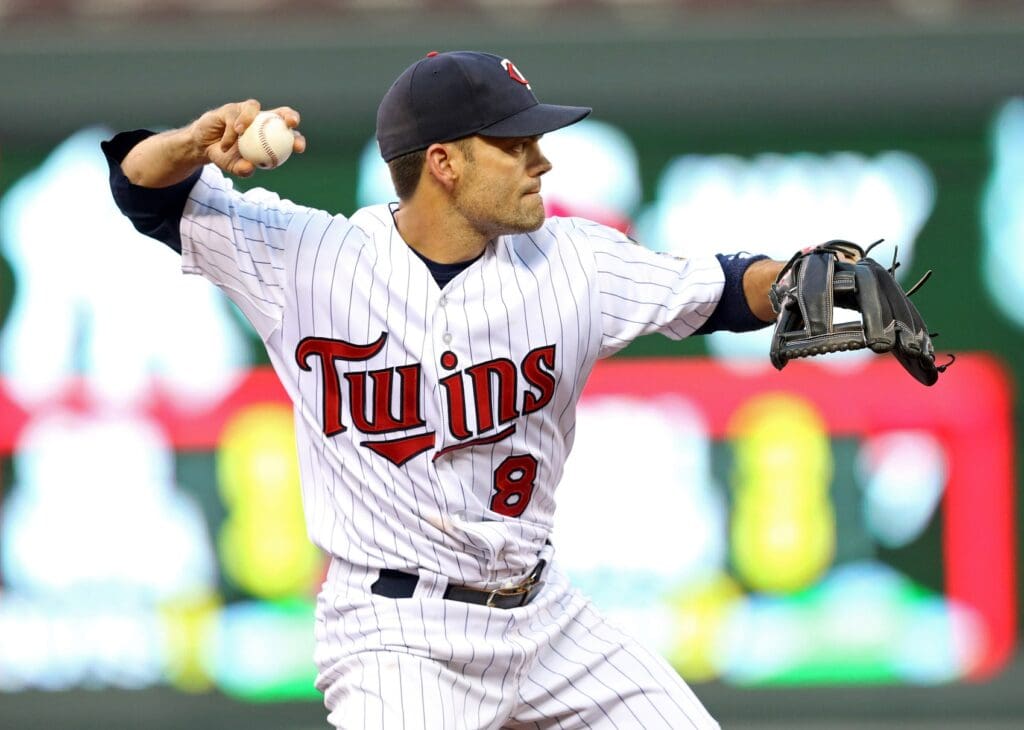 Jul 1, 2013; Minneapolis, MN, USA; Minnesota Twins third baseman Jamey Carroll (8) throws the ball to first base in the fourth inning against the New York Yankees at Target Field.