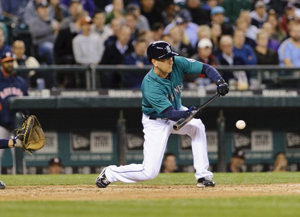Jun 12, 2013; Seattle, WA, USA; Seattle Mariners left fielder Jason Bay (12) hits a bunt single against the Houston Astros during the 8th inning at Safeco Field.