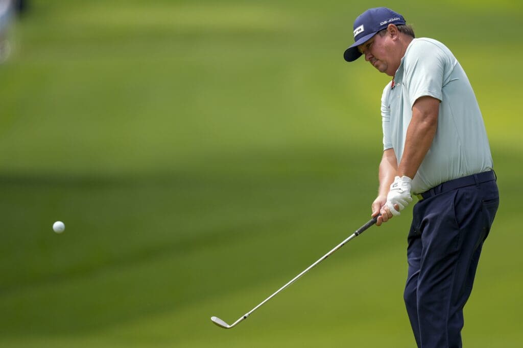 May 14, 2025; Charlotte, North Carolina, USA; Jason Dufner pitches up to the fifth green during a practice round for the PGA Championship golf tournament at Quail Hollow.