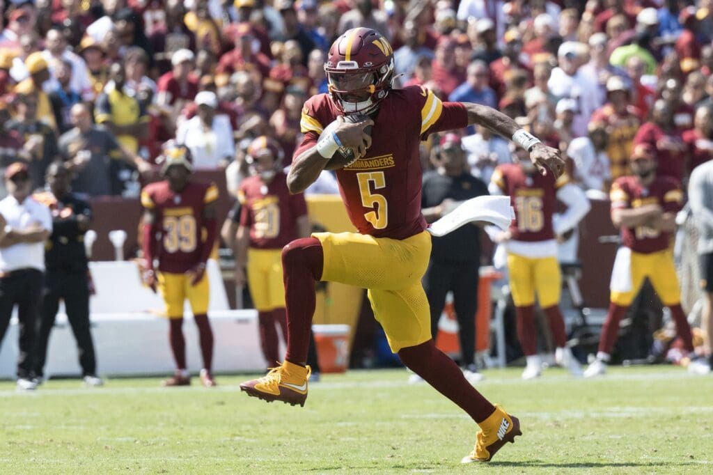 Sep 15, 2024; Landover, Maryland, USA; Washington Commanders quarterback Jayden Daniels (5) runs down the field in the first half against the New York Giants at Commanders Field.