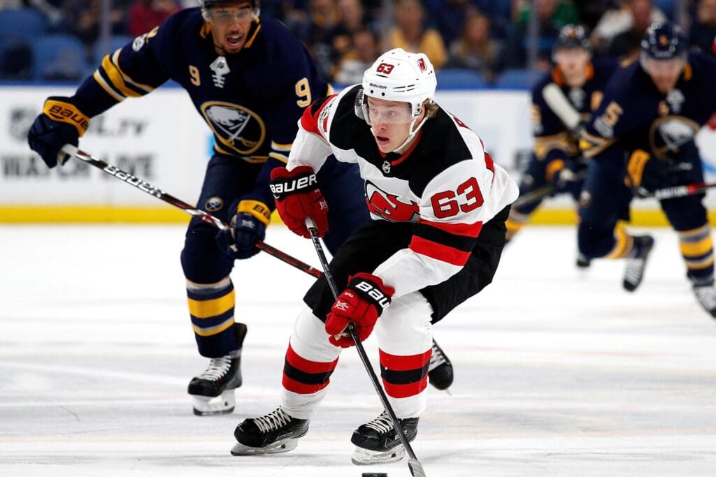 Oct 9, 2017; Buffalo, NY, USA; New Jersey Devils left wing Jesper Bratt (63) with the puck as Buffalo Sabres left wing Evander Kane (9) pursues during the first period at KeyBank Center.