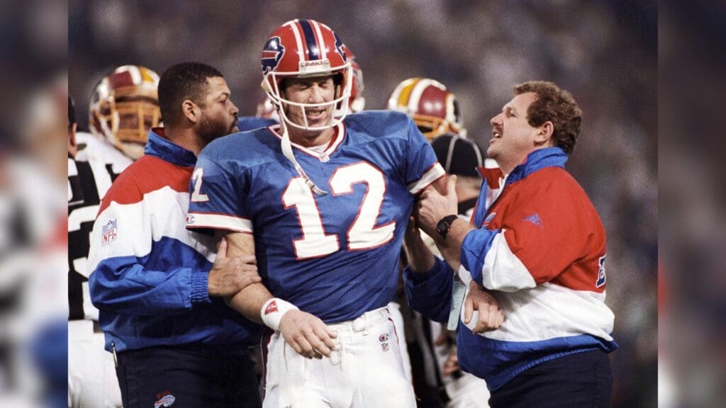 Jan 26, 1992; Minneapolis, MN, USA; FILE PHOTO; Buffalo Bills quarterback Jim Kelly (12) on the field with athletic trainers during Super Bowl XXVI against the Washington Redskins at the Metrodome. The Redskins defeated the Bills 37-24.