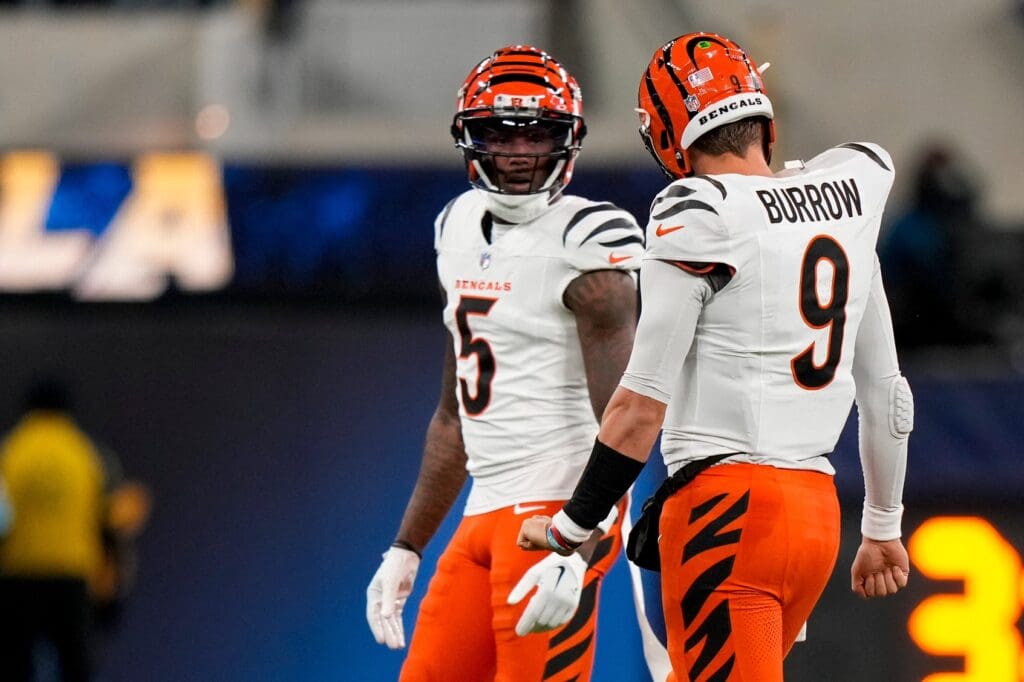 Cincinnati Bengals quarterback Joe Burrow (9) talks with wide receiver Tee Higgins (5) after a play as the punting team takes the field in the second quarter of the NFL Week 11 game between the Los Angeles Chargers and the Cincinnati Bengals at SoFi Stadium in Inglewood, Calif., on Sunday, Nov. 17, 2024. The Chargers led 24-6 at halftime.