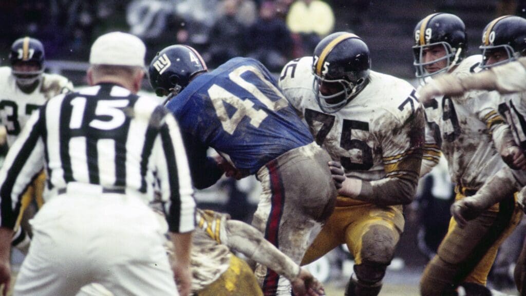 Oct 12, 1969; Bronx, NY, USA; FILE PHOTO; Pittsburgh Steelers defensive tackle Joe Greene (75) tackles New York Giants running back Joe Morrison (40) at Yankee Stadium. The Giants defeated the Steelers 10-7