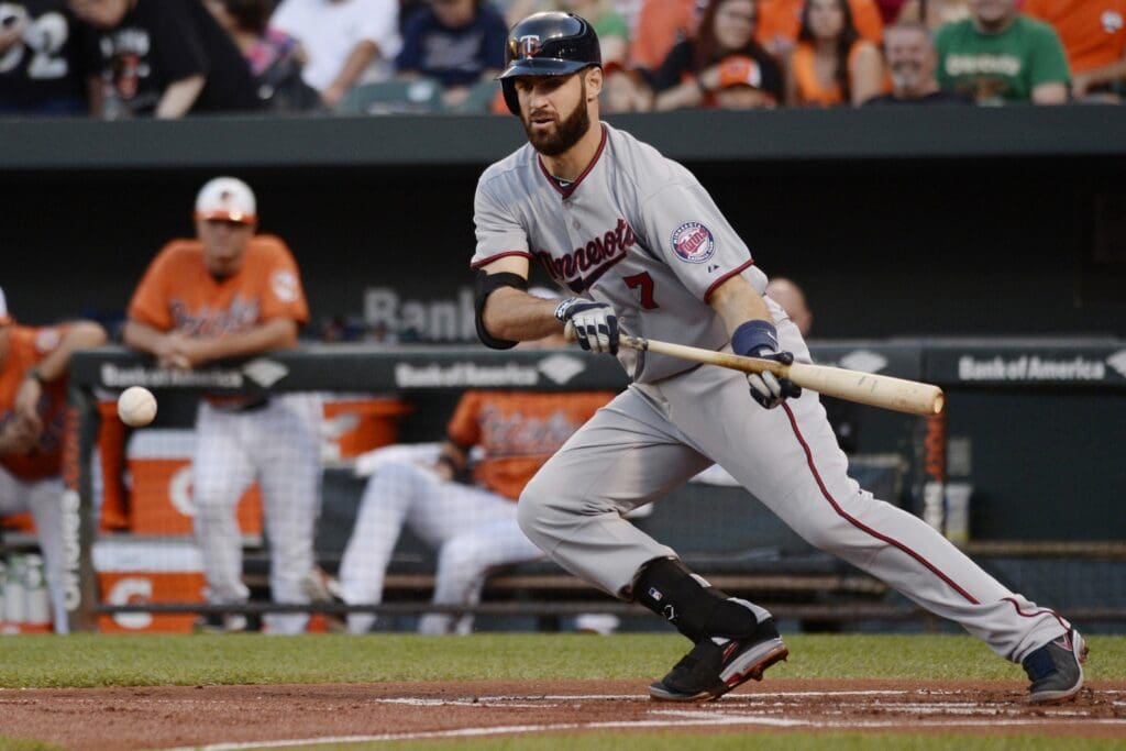 Aug 22, 2015; Baltimore, MD, USA; Minnesota Twins first baseman Joe Mauer (7) hits a bunt single during the first inning against the Minnesota Twins at Oriole Park at Camden Yards.
