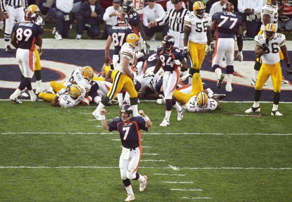 Jan 25, 1998; San Diego, CA, USA; FILE PHOTO; Denver Broncos quarterback John Elway (7) celebrates after a touchdown against the Green Bay Packers during Super Bowl XXXII at Qualcomm Stadium. The Broncos defeated the Packers 31-24.