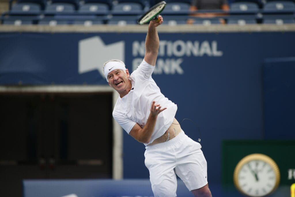 Aug 11, 2013; Toronto,ON, Canada; John McEnroe (USA) serves to Jim Courier (USA) (not pictured) during the Legends exhibition match at the Rexall Centre.