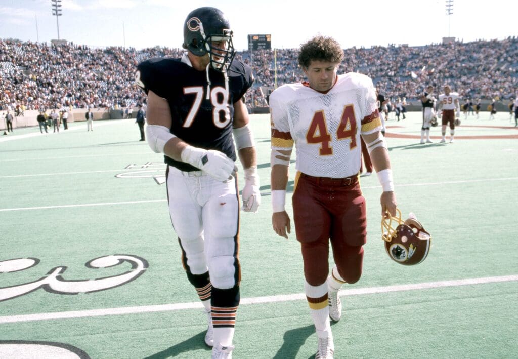 Sep 29, 1985; Chicago, IL, USA: FILE PHOTO; Chicago Bears tackle Keith Van Horne (78) talks to Washington Redskins running back John Riggins (44) as they leave the field following their game at Soldier Field.