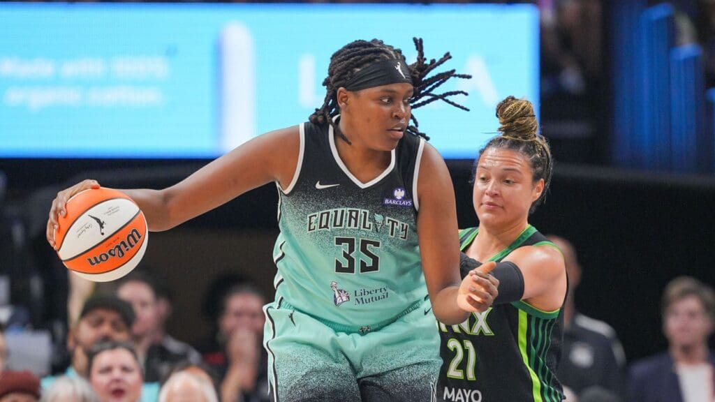 Jul 30, 2025; Minneapolis, Minnesota, USA; New York Liberty center Jonquel Jones (35) dribbles against the Minnesota Lynx guard Kayla McBride (21) in the second quarter at Target Center.