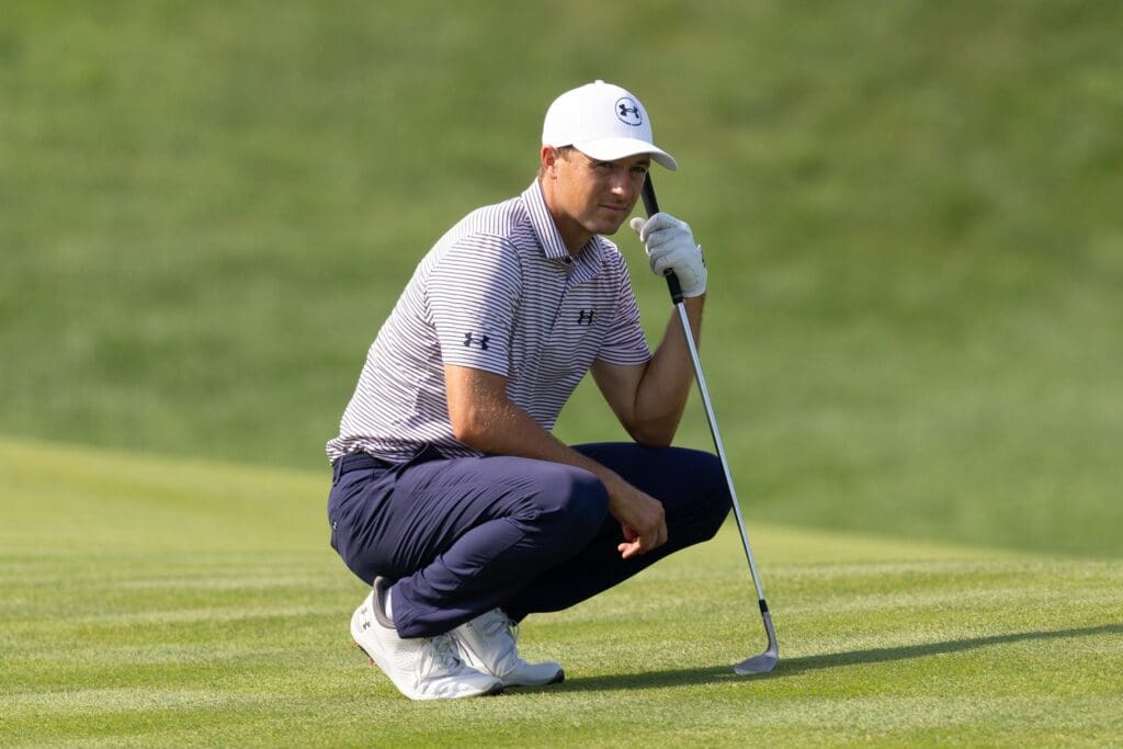 Jun 19, 2025; Cromwell, Connecticut, USA; Jordan Spieth crouches while waiting to play his shot on the 12th hole during the first round of the Travelers Championship golf tournament.