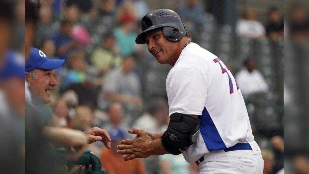 May 23, 2013; Fort Worth, TX, USA; Fort Worth Cats designated hitter Jose Canseco (33) smiles while on deck during the game against the Edinburg Roadrunners at LaGrave Field in Fort Worth.