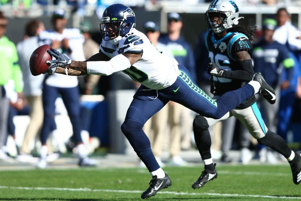 Dec 15, 2019; Charlotte, NC, USA; Seattle Seahawks wide receiver Josh Gordon (10) catches a pass against Carolina Panthers cornerback Donte Jackson (26) during the second quarter at Bank of America Stadium.