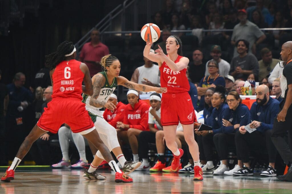 Jun 24, 2025; Seattle, Washington, USA; Indiana Fever guard Caitlin Clark (22) passes the ball during the first half against the Seattle Storm at Climate Pledge Arena.