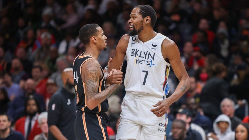 Dec 28, 2022; Atlanta, Georgia, USA; Atlanta Hawks guard Dejounte Murray (5) talks to Brooklyn Nets forward Kevin Durant (7) in the second quarter at State Farm Arena.
