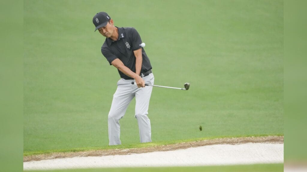 Apr 6, 2023; Augusta, Georgia, USA; Kevin Na chips onto the second green during the first round of The Masters golf tournament.