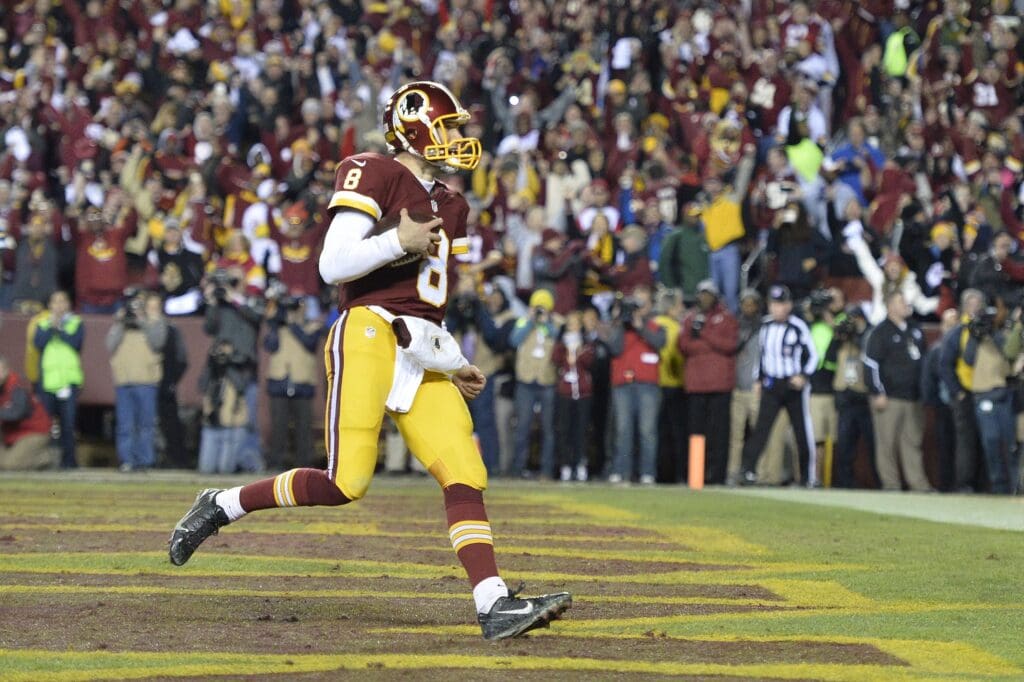 Jan 10, 2016; Landover, MD, USA; Washington Redskins quarterback Kirk Cousins (8) scores a touchdown against the Green Bay Packers during the second half in a NFC Wild Card playoff football game at FedEx Field.