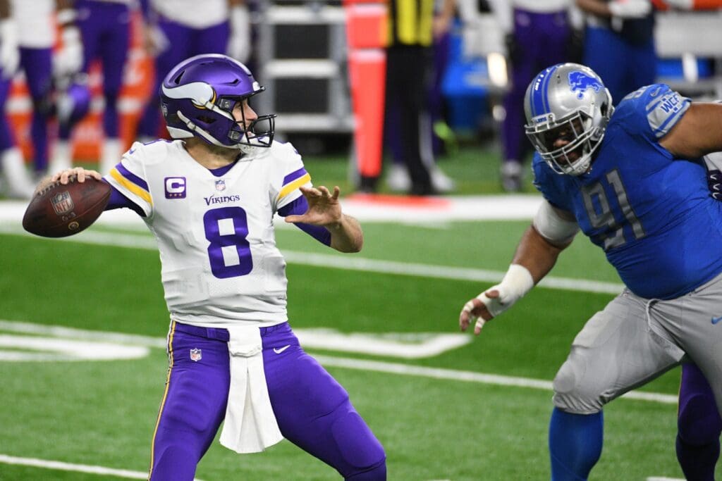 Jan 3, 2021; Detroit, Michigan, USA; Minnesota Vikings quarterback Kirk Cousins (8) throws a pass as Detroit Lions defensive tackle John Penisini (91) pressures during the first quarter at Ford Field.