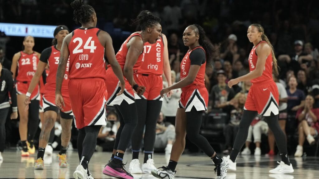 Jul 22, 2025; Las Vegas, Nevada, USA; Las Vegas Aces guard Chelsea Gray (12) reacts to guard Dana Evans (11) during a timeout in the second quarter of their game against the Atlanta Dream at Michelob Ultra Arena