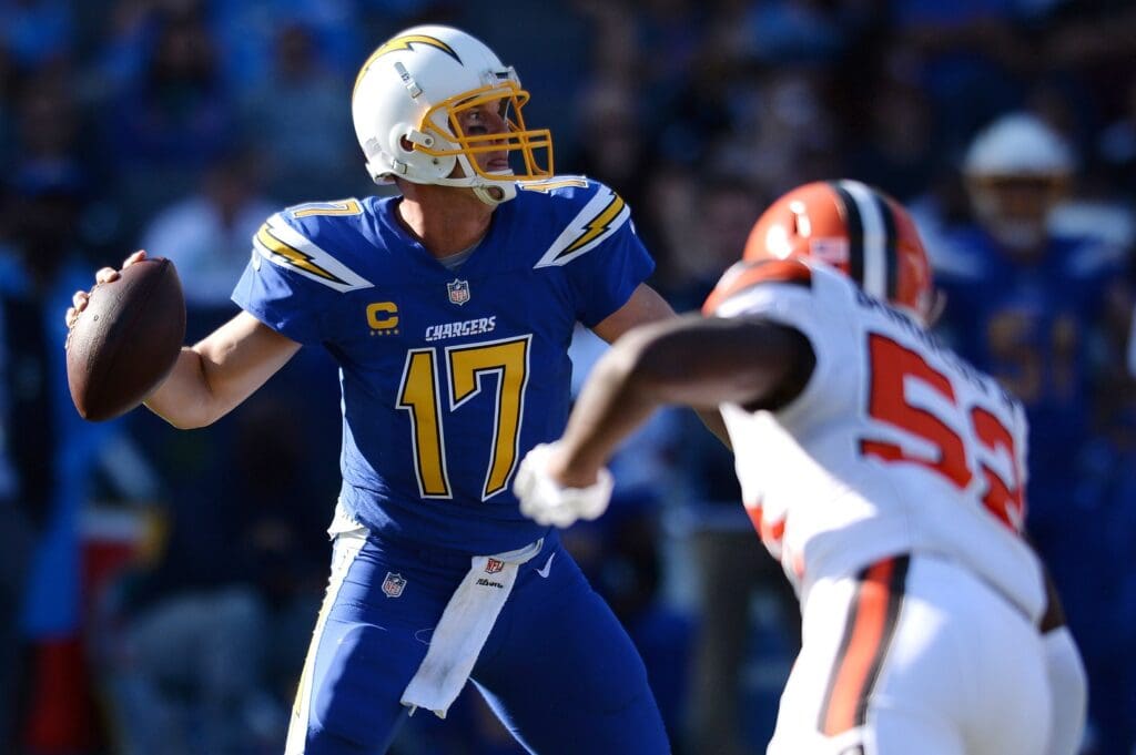 Dec 3, 2017; Carson, CA, USA; Los Angeles Chargers quarterback Philip Rivers (17) throws a pass while pressured by Cleveland Browns outside linebacker James Burgess (52) during the second quarter at StubHub Center.