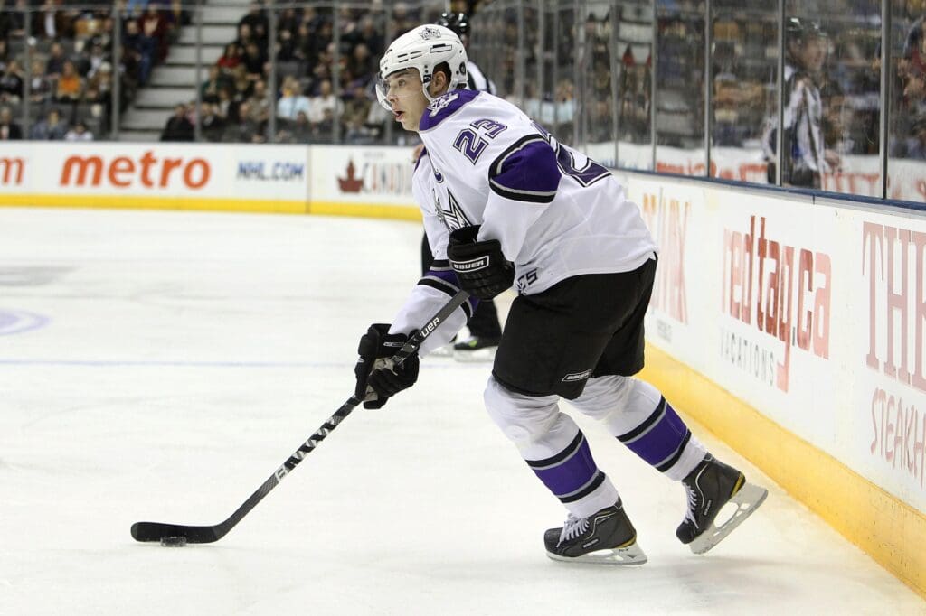 Jan 26, 2010; Toronto, ON, Canada; Los Angeles Kings right wing Dustin Brown (23) controls the puck against the Toronto Maple Leafs at the Air Canada Centre. The Kings beat the Maple Leafs 5-3.